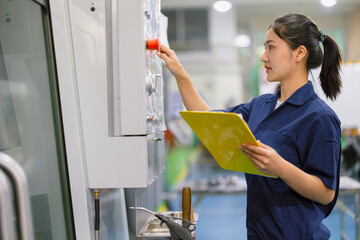 Engineer women control operate CNC industrial machine in metal production workshop. Asian young female industry worker. - obrazy, fototapety, plakaty