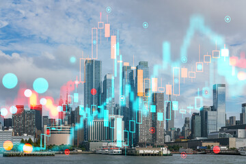 A cityscape with overlaying holographic data graphics, on a partly cloudy day. Technology and urban concept. Double exposure