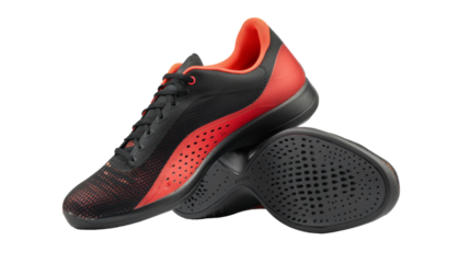 A pair of sleek black and red shoes stand out on a crisp white background