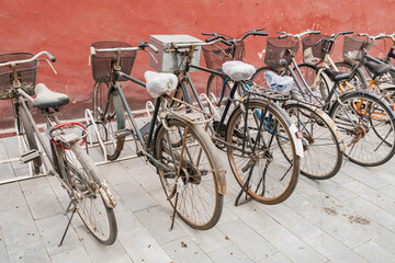 Private retro bicycles stand near the wall. - 773987502
