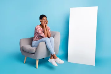 Foto op Canvas Full size photo of young cheerful man woman sit lounger promoter hands touch cheeks isolated over blue color background © deagreez
