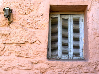 A window with French style grey shutters on ocher wall. Space for text and logo. - 773994118