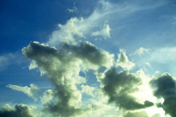 Fototapeta premium Landscape with big heavy fluffy clouds on a blue background