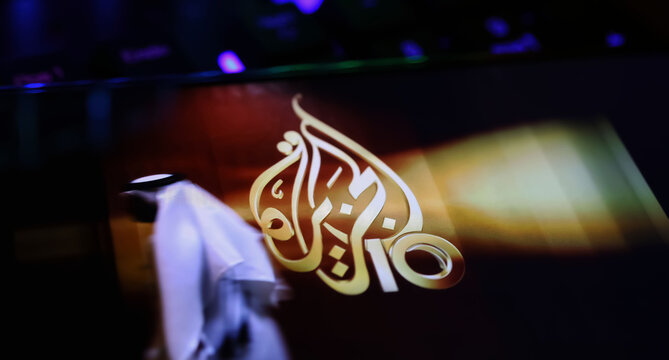 Viersen, Germany - April 1. 2024: Smartphone screen on computer keyboard with logo of Al Jazeera arabic television