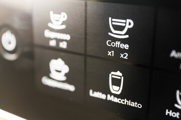 Buttons with inscriptions of types of coffee for preparation in the coffee machine (coffee, cappuccino, latte)