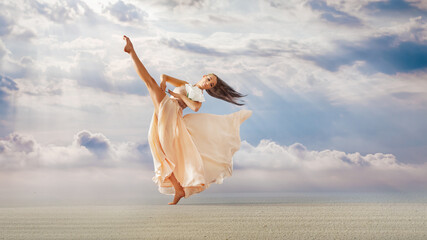 Fit woman walks towards wind, graceful dancing girl in image of flower with flying long hem of dress