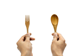 Man's hand holding a wooden spoon and fork on white background