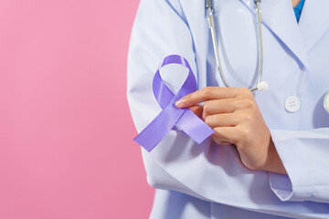 Prostate cancer awareness. Close up medical doctor holding ribbon over pink background isolated....