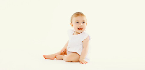 Happy cute baby crawling on the floor on white studio background