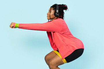 Woman in sportswear squatting with yellow fitness band, showcasing a healthy lifestyle and workout...
