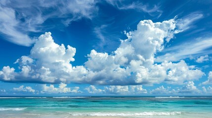 Beautiful tropical empty beach sea ocean with white cloud on blue sky background
