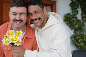 Man gifting flowers to his handsome boyfriend 