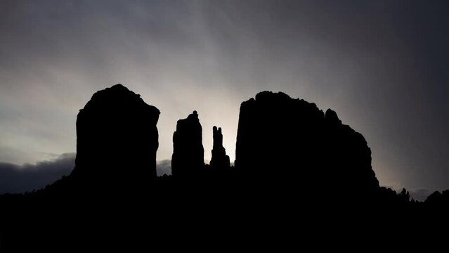 Arizona: Sedona Cathedral Rock at Sunrise, Time Lapse  with Fast Clouds and Dark Silhouette of Natural Landmark in USA