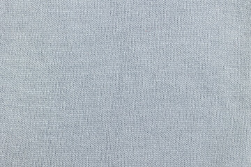 Gray knitted fabric as a background. Knitted wool texture. 