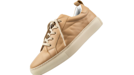 A tan sneaker with a white sole basking in the sunlight, showcasing its sleek design and impeccable craftsmanship