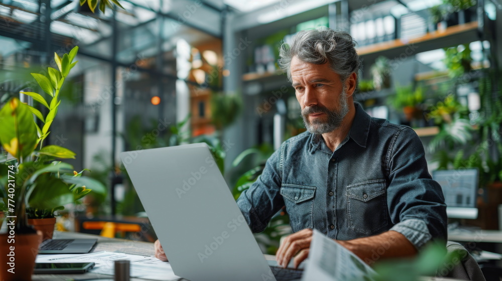 Poster man working on laptop at table