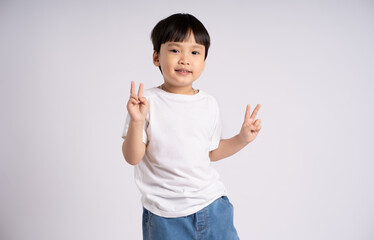 Portrait of an Asian boy posing on the white background