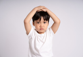 Portrait of an Asian boy posing on the white background © STOCK88PHOTOGRAPHER