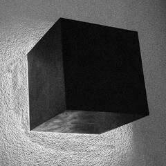 cubo negro adosado a una pared blanca