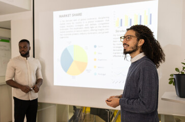 Business colleagues analyzing market data in meeting