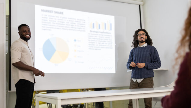 Diverse team presenting business data in meeting