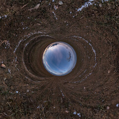 blue hole sphere little planet inside sand or dry grass round frame background