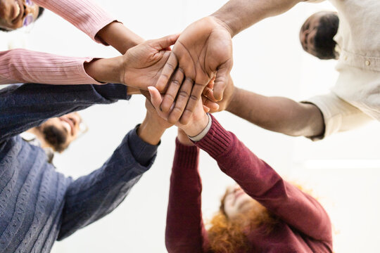Diverse Team Stack Hands in Unity and Teamwork