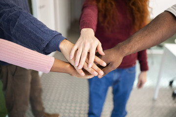 Diverse hands together in a gesture of teamwork