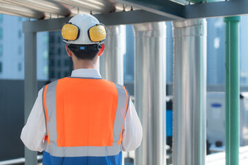Back view of Engineers inspect the completed air conditioning and water systems to continue...