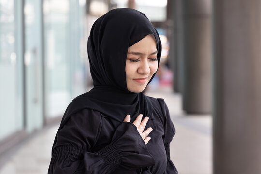 ill Muslim woman with acid reflux or gerd symptoms, acidic esophageal sickness, health care for Islamic people concept image