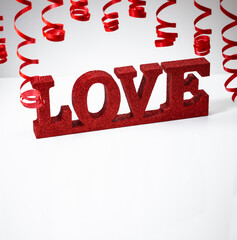 Red ribbon and word love over isolated white background - 774040560