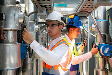 Engineers and technicians Inspect the completed air conditioning and water systems to continue verifying their functionality. - obrazy, fototapety, plakaty