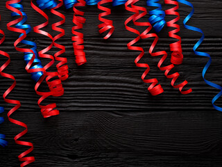 red and blue streamer ribbon on a black - 774041781