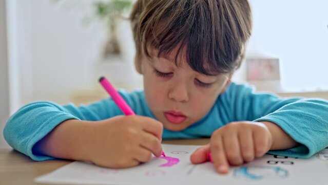 Little Boy Outlining Letter As A Training Exercise To Start Writing