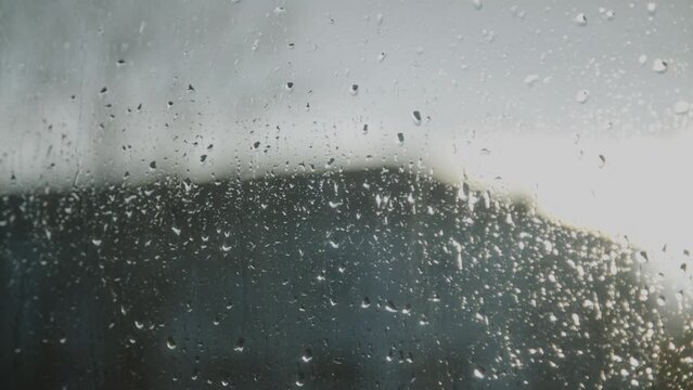 Water Drops following down. Drops of Rain trickling down on window. Sad atmosphere . High quality 4k footage