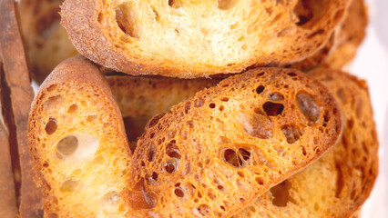Close-up of baguette croutons, Toasts, bruschetta from sliced baguette, close up view, Toasted...