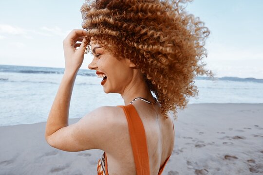 Joyful Hippie Beach Vacation: Smiling Woman with Backpack Embracing Freedom and Happiness