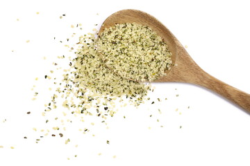 Peeled hemp seed in wooden spoon isolated on white background, top view	