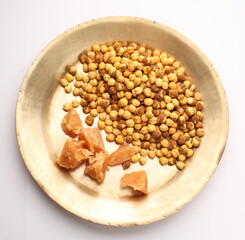 Gud or jaggery and chana or roasted gram, a healthy snack