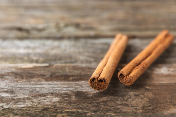 Ceylon cinnamon.Cinnamon sticks on a textured wooden background. Cinnamon roll and powder. Spicy spice for baking, desserts and drinks. Fragrant ground cinnamon. Close-up. Place for text. copy space
