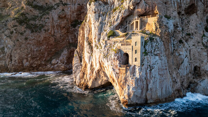 Rough sea in Sardinia near Porto Flavia. Aerial view of Pan di Zucchero and crystal clear sea