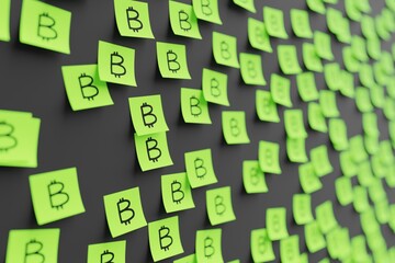Many green stickers on black board background with bitcoin symbol drawn on them. Closeup view with...