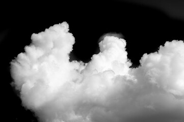 White cloud on a black background. The sharp contrast between the white cloud and the black background creates a striking visual effect. Symbolizes purity, simplicity and clarity.