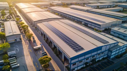 Fotobehang An industrial complex with a green twist, its buildings and parking canopies covered in solar panels, demonstrating the role of renewable energy in reducing the carbon footprint of manufacturing. © Filip