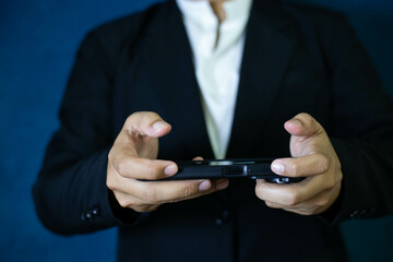 Business man's hand holding a smartphone Use online apps and mobile virtual services Send messages and chat with messengers, buy online, read books, articles, get close.