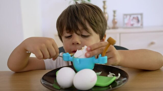 Kid Enjoys Soft-Centered Boiled Egg In Playful Egg Holder