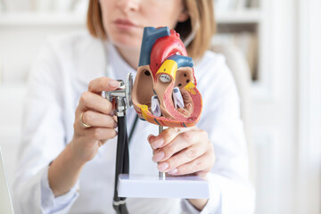 Portrait of young female doctor cardiologist working in office of modern clinic	