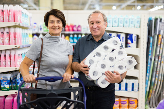 Elderly man and elderly woman choose toilet paper