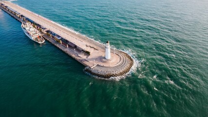 Aerial photograph of a lighthouse in the sea (Qingdao, Shandong Province, China) - obrazy, fototapety, plakaty