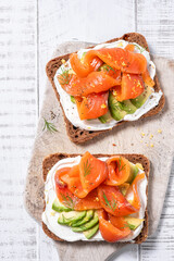 Two open sandwich, toast with salmon, cream cheese, avocado